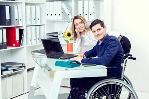 Integración laboral de las personas con discapacidad (Una persona en silla de ruedas en su puesto de trabajo)