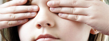 Una niña con los ojos tapados, representando la discapacidad visual