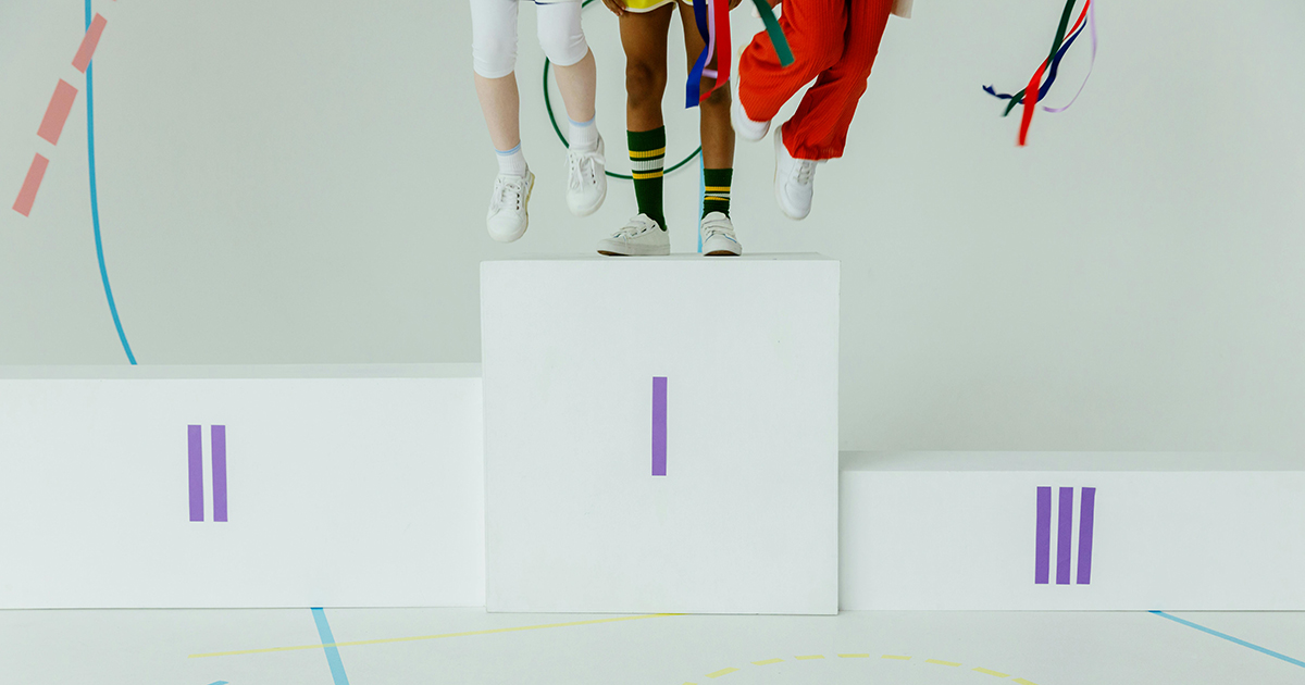 Pódium en donde aparecen tres deportistas subido en el primer peldaño