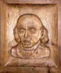 Foto de una talla en madera de la cara de un hombre con la enfermedad de Crohn