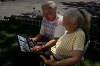 Pareja de ancianos viendo unas fotos con Esclerosis Lateral Amiatrófica