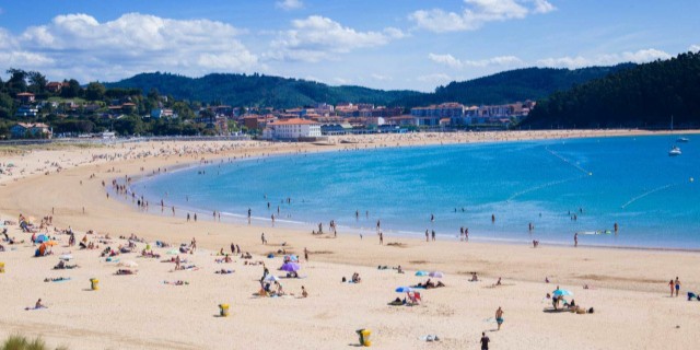 Playa de Gorliz con bastante gente bañándose y tomando el sol