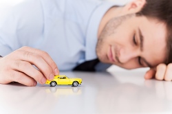 joven con coche de juguete