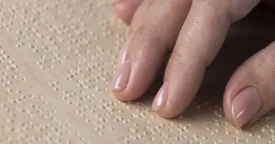 Mano de una persona leyendo un libro en braille (Servimedia)