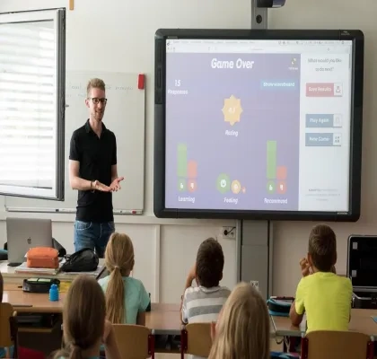 Profesor en una clase enseñando a niños con una pizarra digital