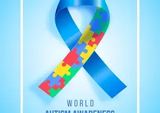 cartel con un lazo azul y construido por piezas de colores que simbolizan el día mundial de la concienciación del autismo en inglés